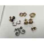 A collection of gold earrings white and yellow gol