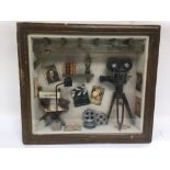 A framed and glazed diorama of early cinema intere