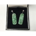 A pair of white gold, diamond and carved jade pend