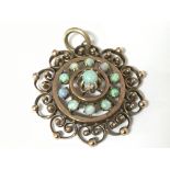 An unmarked gold pendent set with opals In an open
