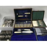 A collection of boxed and loose cutlery.