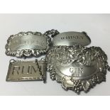 Four silver wine labels of various design. Weight