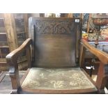 A carved oak hall seat with a hinged back.