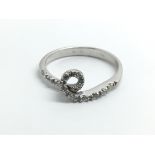 An 18ct white gold and diamond ring in the shape o