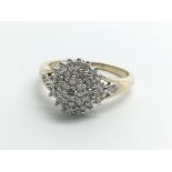 A 9ct yellow gold and diamond cluster ring, size a