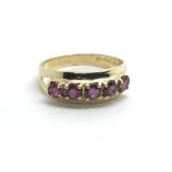 A 9ct yellow gold ring with a row of five rubies,
