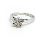 An 18ct white gold and diamond cluster ring, appro