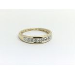 A 9ct yellow gold half eternity ring having seven