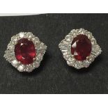 A pair of white gold treated ruby and diamond clus