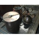 A collection of antique copper jugs and a copper p