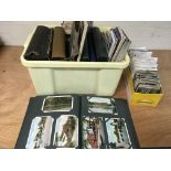 A box containing a collection of postcards, mainly
