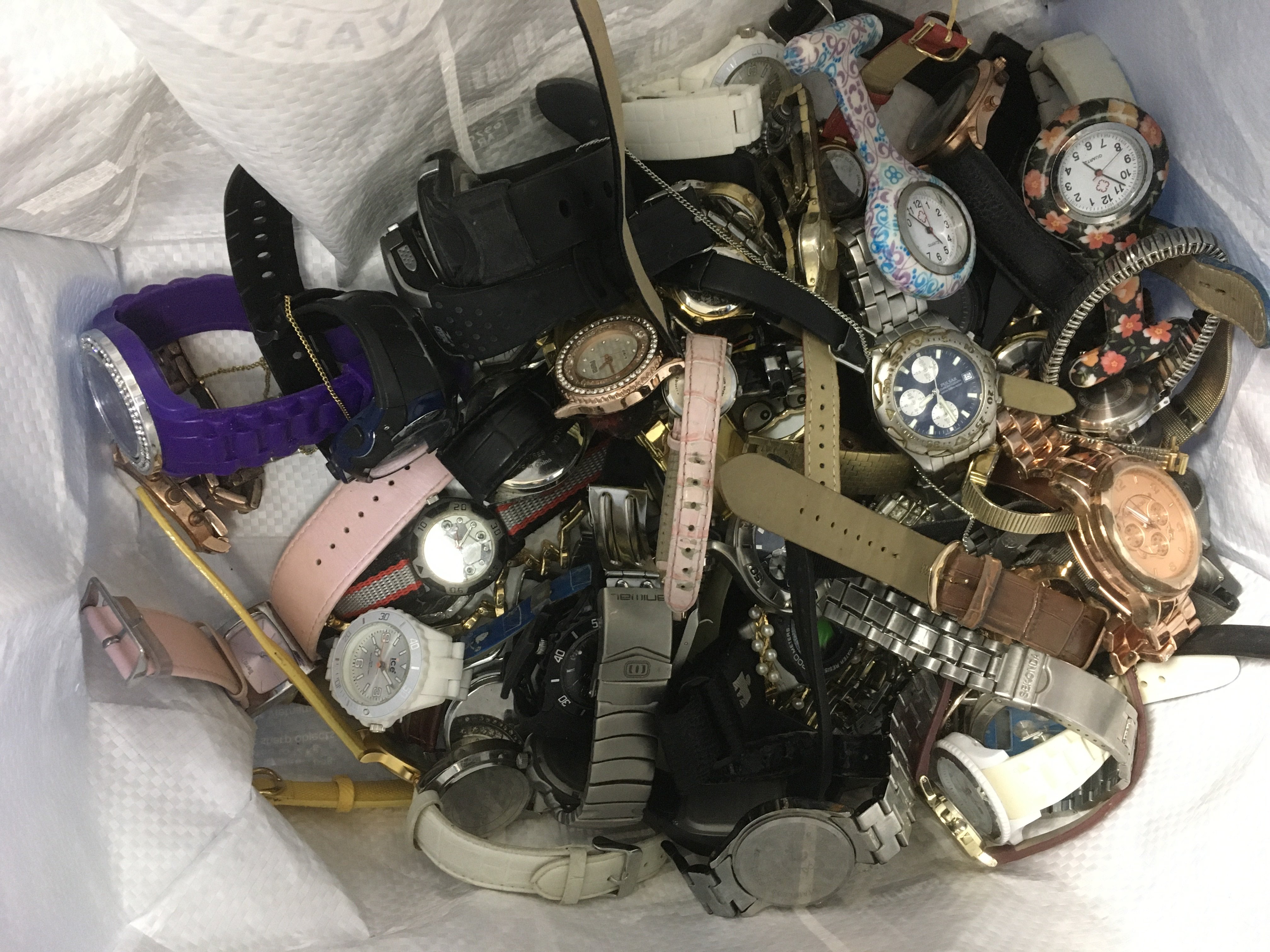 A bag of used designer quartz watches.