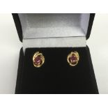 A pair of 18ct gold and ruby earrings, approx 1.2g
