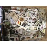 A box of mixed cigarette cards