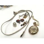A white metal necklace a silver thimble and earrin