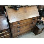 A large Georgian fall front oak bureau with turned