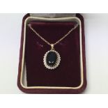 A 9ct gold, diamond and sapphire pendant and chain