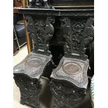 A pair of oak hall chairs with carved back and sea
