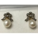 A pair of pearl earrings with diamond bow tops, bo