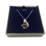 A 9ct white gold garnet and diamond pendant, appro