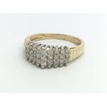 A 9ct yellow gold ring having three rows of diamon