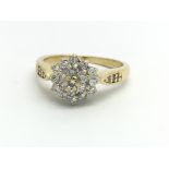 An 18ct yellow gold and diamond cluster ring, appr