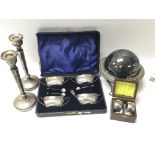 A pair of silver candle sticks loaded bases a case