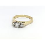 An 18ct yellow gold and three stone diamond ring,