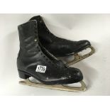 A pair of ice skates with leather boots