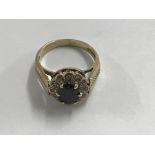 A 9 ct ring with central stone and diamond chip su