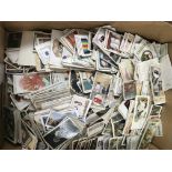 A box of mixed cigarette cards