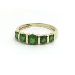 A 9ct yellow gold and five stone peridot ring, siz