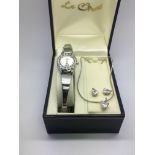 A boxed ladies watch, pendant and earrings set.