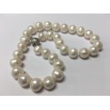 A string of cultured pearls with a 9ct white gold