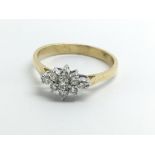 An 18ct yellow gold ring set with a cluster of nin