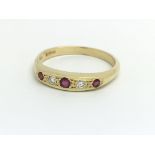 An 18ct yellow gold, diamond and ruby ring, size a