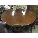 A large Victorian circular mahogany dining table.