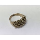A gents 9ct gold keeper ring, 9.5g. (V).