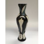 A Moorcroft vase of tapering form and decorated wi