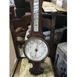 A oak barometer with applied thermometer