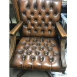 A reproduction pedestal desk with leather studded