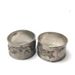 Two Chinese white metal napkin rings decorated wit