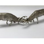 A pair of cast silver figures in the form of rutti