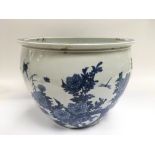 A blue and white fish bowl decorated with flowers