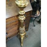 A gilt torchere of classical style . 130 cm .