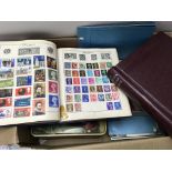 A box of mixed looses stamps and stamp albums.