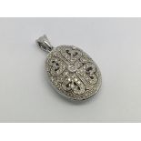 A 9ct white gold and diamond locket pendant, appro