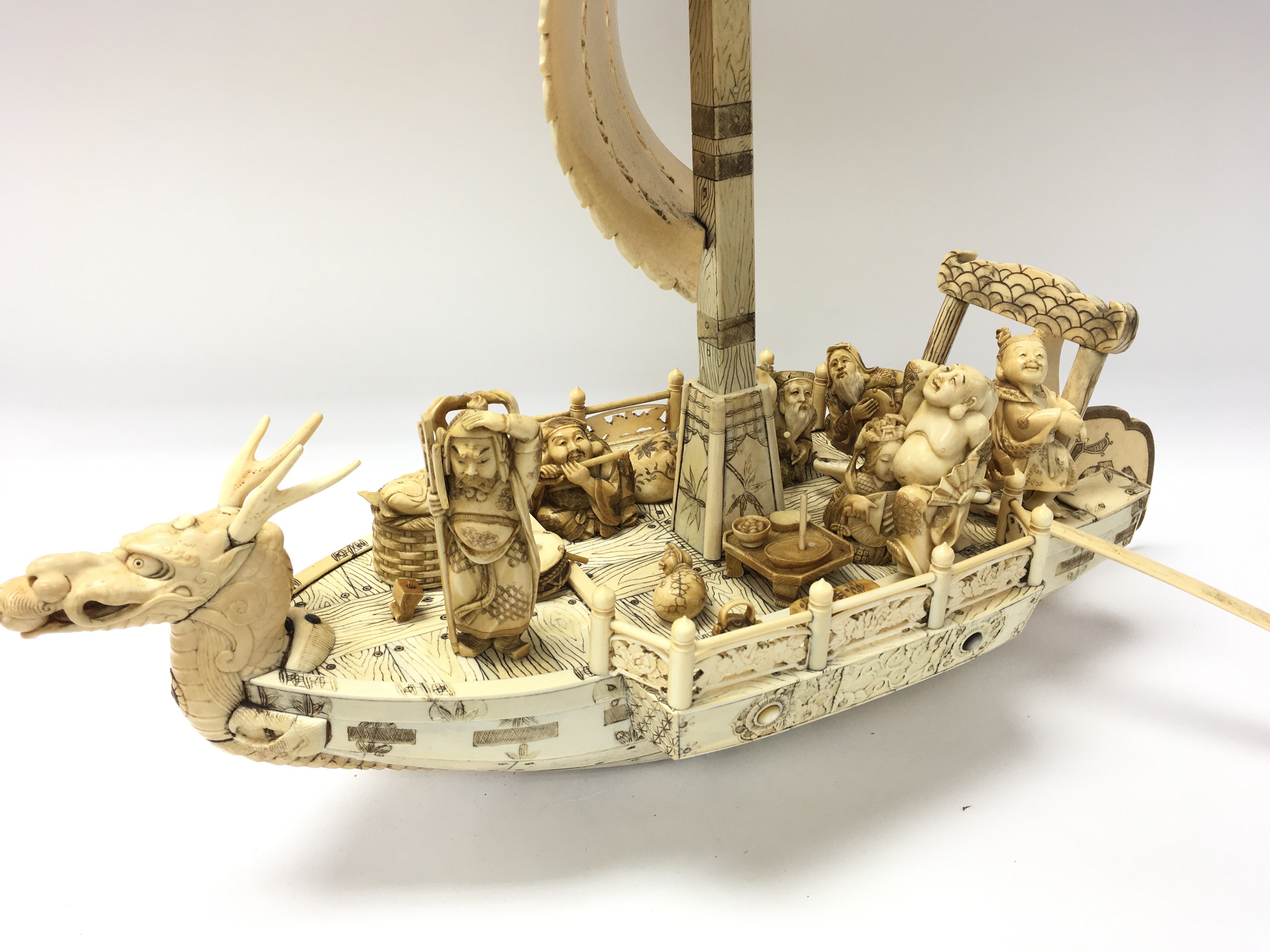 A large carved Chinese Model of a dragon boat with