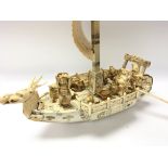 A large carved Chinese Model of a dragon boat with