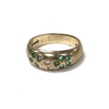 A 9carat gold ring set with a pattern of green eme